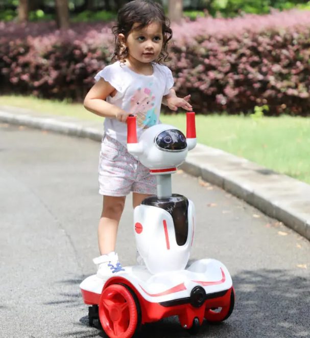 A kid is riding the Tobbi robot buggy.