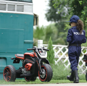 A kid prepares to ride a kids motorcycle.