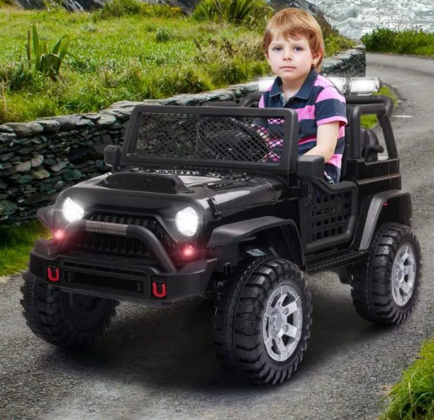 A kid is playing with kids ride on car.