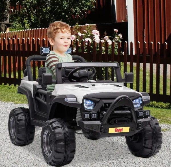 A kid is playing with kids ride on car.