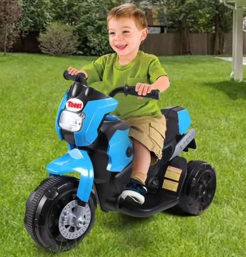 A kid is riding the kids motorcycle.