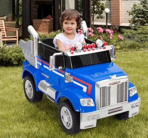 A kid is riding the kids ride on car.