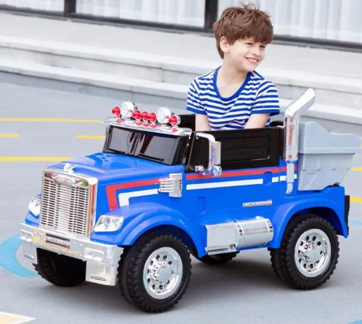 A kid is playing with kids ride on car.