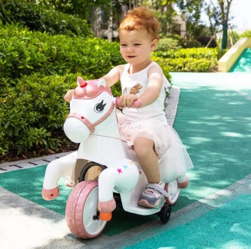 A kid is riding the unicorn ride on toy.