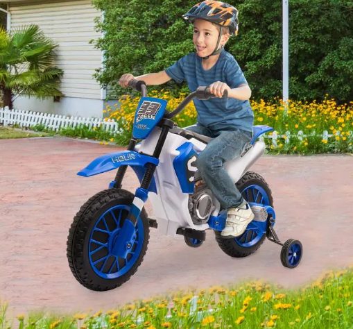A kid is riding the kids motorcycle.